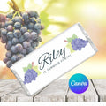 Personalized chocolate bar with grapes and text 'Riley is turning forty!' on a wooden surface with grapes in the background.