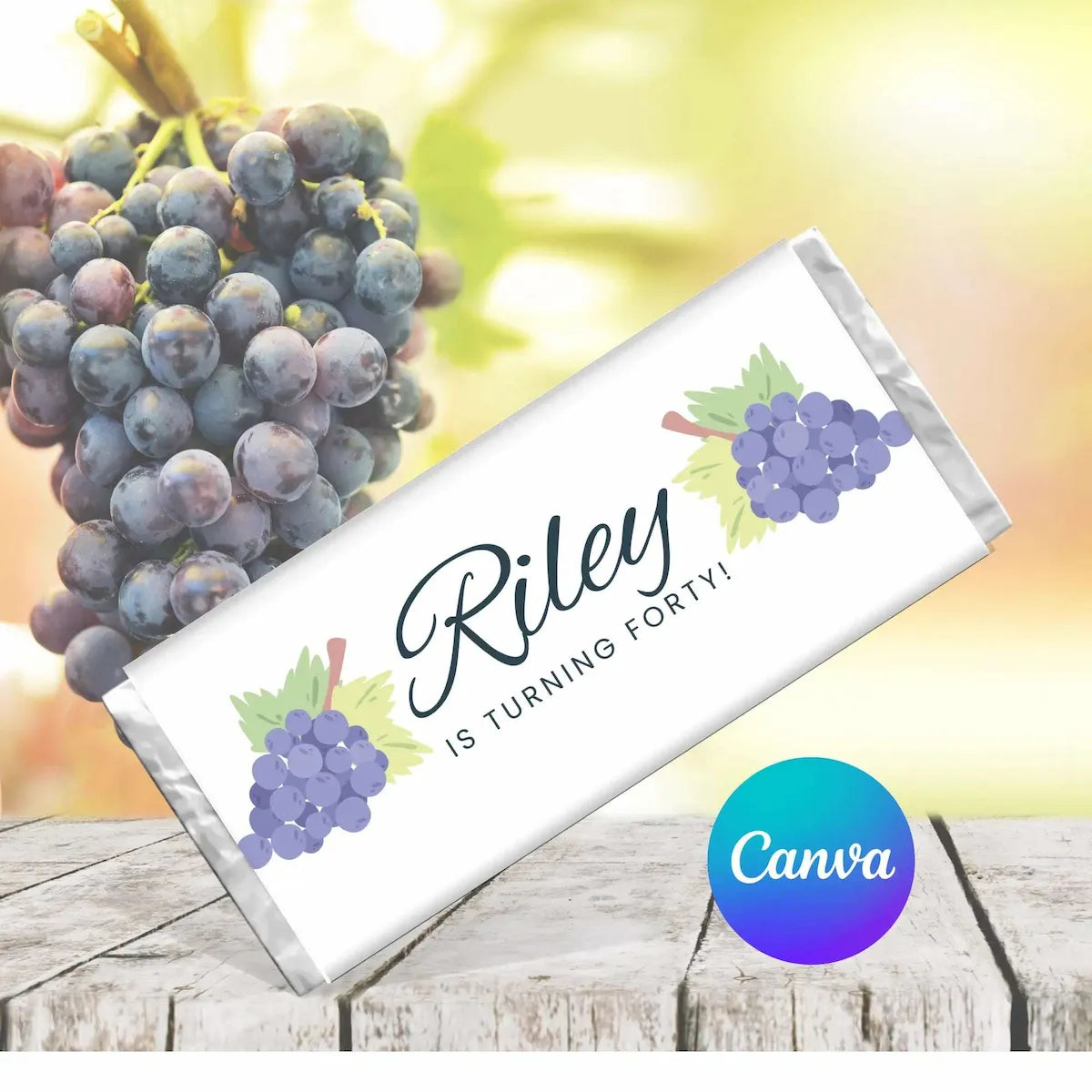 Personalized chocolate bar with grapes and text 'Riley is turning forty!' on a wooden surface with grapes in the background.