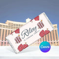 Personalized birthday banner with 'Riley is turning thirty!' text and dice design, against a cityscape background.