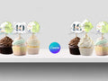 Decorative cupcake toppers with numbers and text on a white surface, featuring the Canva logo.